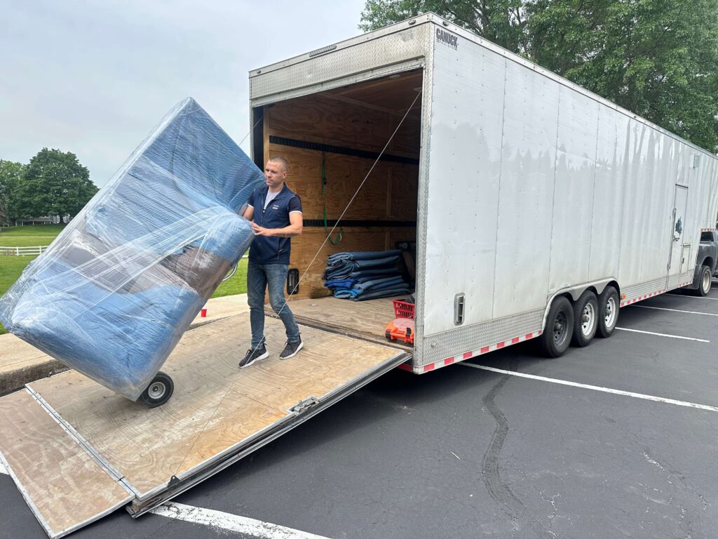 Movers loading wrapped furniture into truck for a long-distance move in Etobicoke